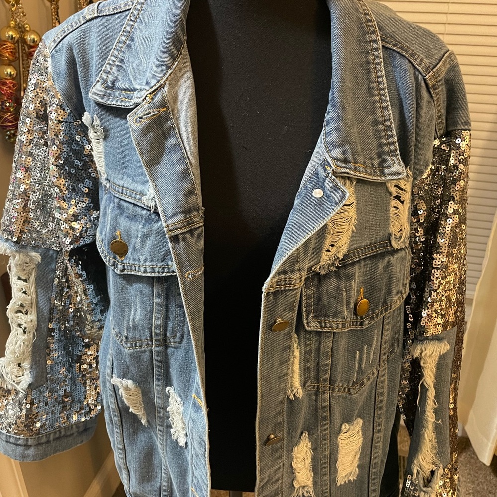 Distressed Jean jacket with sequins.